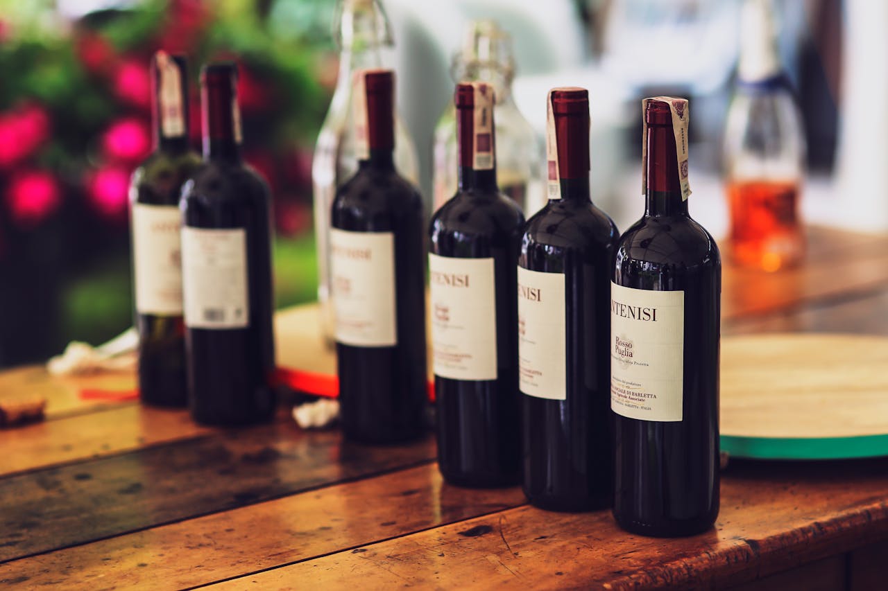 Cozy dinner setup featuring multiple wine bottles on a wooden table, ideal for special occasions.