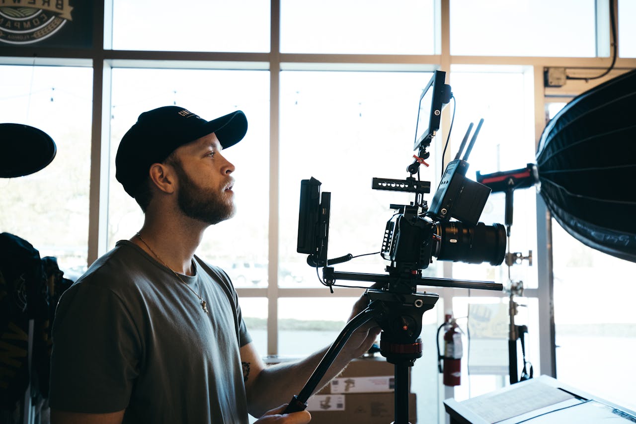 The Art of Drawing Readers In: Your attractive post title goes here A focused filmmaker operates a professional camera rig indoors, surrounded by equipment.